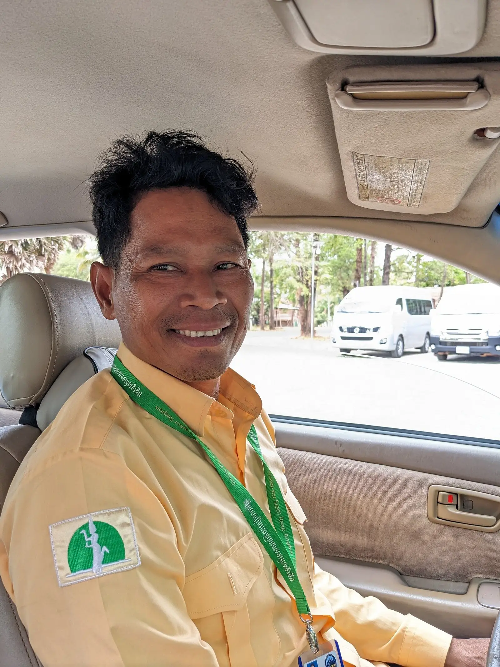 San Park, licensed Angkor tour guide, smiling in his guide uniform