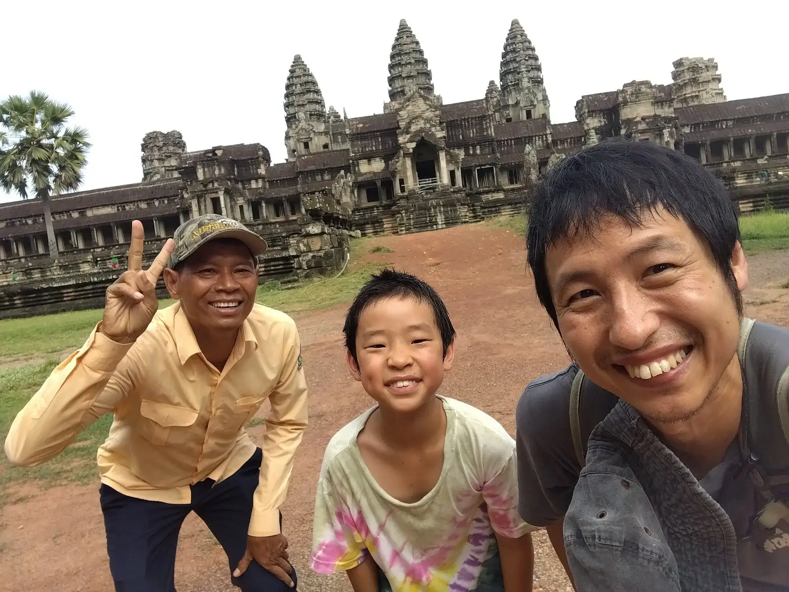 San with a father and son in front of the towers of Angkor Wat
